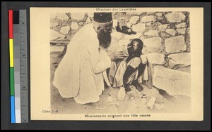 Missionary father applying liquid to a boy's head, Congo, ca.1920-1940