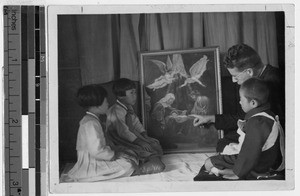 Father Carroll, MM, explains the meaning of the nativity to children, Korea, ca. 1930-1950