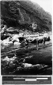 Three men guiding logs down a river, Japan, ca. 1930-1950