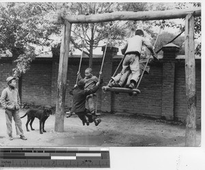 Children playing on swings at Fushun, China, 1940