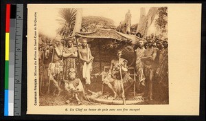 Chief seated beneath an awning with masked man, Cameroon, ca.1920-1940