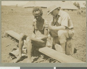 Dr Irvine examining a patient, Chogoria, Kenya, ca.1924