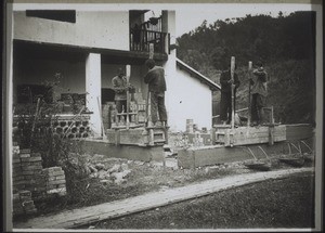 Chinese masons pounding the concrete walls, which set as hard as stone