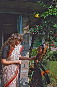 Saraswatipur, Bangladesh. Missionary Anni Schrøder meeting another woman at the door, hoping fo