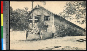 Brick church standing behind a crucifix statue, Congo, ca.1920-1940