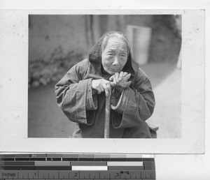 An elderly woman with a cane in China, 1941