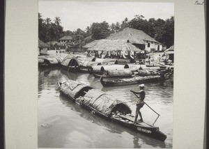 India (s), Travancore, Kottayam: River-side. A canoe with a cargo of coconuts on the river-side at Kottayam