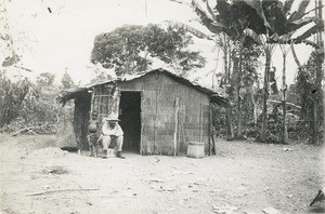 Missionary in front of a house, in Gabon
