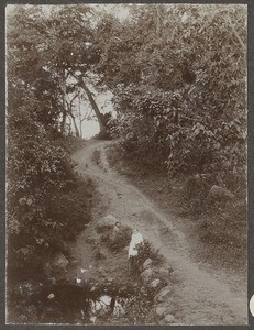 European woman sitting at a pond, Tanzania