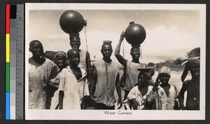 Group of men and boys carrying water, Nigeria, ca.1920-1940