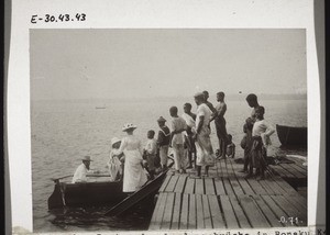 Climbing into a boat from the jetty in Bonaku