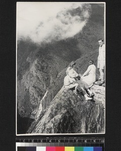 Family seated on rock, Kuling pass, China, ca. 1940