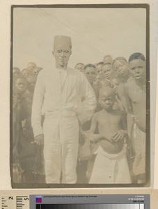 African man in Fez with children, Mozambique, ca.1925