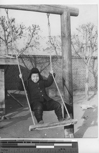 A small boy on a swing at Fushun, China, 1938