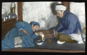 Two people smoking opium indoors, China, ca.1917-1923