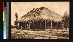 Men laboring to thatch a school building, Angola, ca.1920-1940