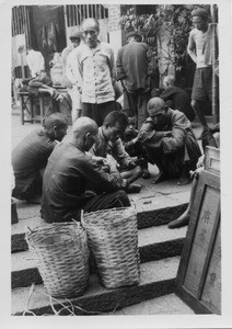 Men gambling on Hong Kong street, China, 1940