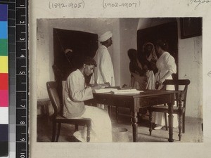 Medical personnel and patients in office, India, ca. 1910