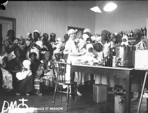 Female medical missionary weighing babies, Maputo, Mozambique, ca. 1929