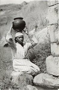 Young malagasy woman after drawing water, in Madagascar