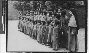 Maryknoll Sister with an orphans at Fushun, China, 1938