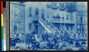 Orphans gathered outside a very large wooden building, Canada, ca.1920-1940