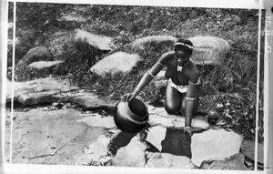 African girl drawing water, southern Africa