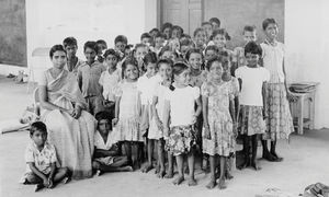 South Arcot District, India. Grade 3 children at the Neyveli School with their teacher, Mrs Joy