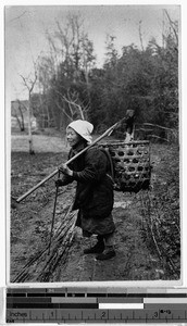 Elderly Japanese woman standing on a dirt road, Japan, ca. 1942