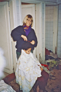 A DMS volunteer is cutting the hair on a girl at Fowlers orphanage 1992. Keeping the girls' hai