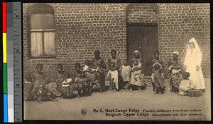 Missionary sister standing with women and infants, Congo, ca.1920-1940