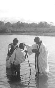Baptism at Aronpur, 11/19/1950. Rev. Ratu Marandi baptizing an old woman. (Ratu Marandi, 1896-1