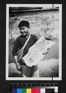 Boy selling newspapers, China, ca. 1945