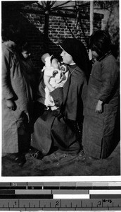 Maryknoll Sister with a group of Chinese children, Fushun, China, ca. 1930