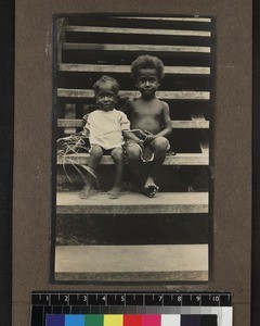 Two children seated on steps, Mailu, Papua New Guinea, ca.1905