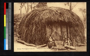 Two women seated outside of a hut, Angola, ca.1920-1940