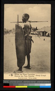 Man standing with shield and spear, Congo, ca.1920-1940