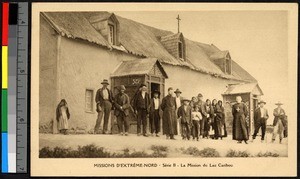 Missionary father and others standing before a wooden building, Canada, ca.1920-1940