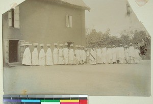 Malagasy men and women lined up in the courtyard, Soatanana, Madagascar, ca.1900