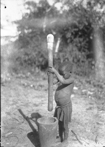 African child pounding, Chicumbane, Mozambique, 1930