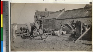 Men sawing wood outside missionaries' homes, Haizhou, China, 1910