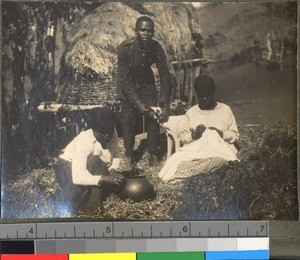 A man with a dog and two women working, KwaZulu-Natal, South Africa, ca.1915-1925