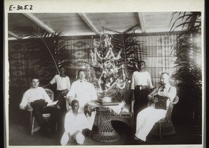 Christmas celebration in the Bonaku Mission trading store (Cameroon). Rev. Fuchs, a guest, Rev. K. Hoffmann, official of the North West Cameroon Company