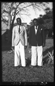 African men standing in front of a building, Mozambique, ca. 1940-1950