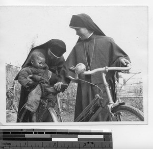 Maryknoll Sisters take a passenger on a bike ride at Meixien, China, 1948