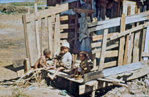 Mission at the bottom - City Mission in Madagascar. Children outside the house in which they li