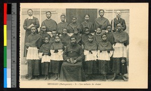 Choirboys gathered with missionary father and indigenous priest, Madagascar, ca.1920-1940