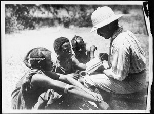 Missionary Guth presenting a Testament in Swahili, Tanzania, ca. 1927-1938