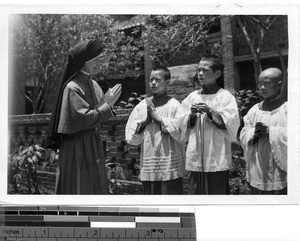 A Maryknoll Sister with altar boys at Lipu, China, 1948