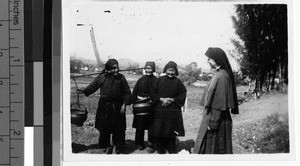 Maryknoll Sister greets three women Shuichai, Kaying, China, ca. 1940